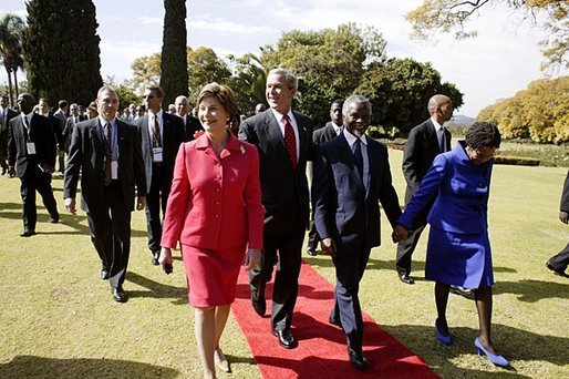 Presidents Bush and Mbeki walk together with Mrs. Bush and Mrs. Mbeki after speaking to the media at the Guest House in Pretoria, South Africa, Wednesday, July 9, 2003. White House photo by Paul Morse