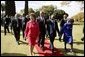 Presidents Bush and Mbeki walk together with Mrs. Bush and Mrs. Mbeki after speaking to the media at the Guest House in Pretoria, South Africa, Wednesday, July 9, 2003. White House photo by Paul Morse.