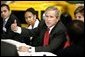 President George W. Bush talks with Ford Motor Company employees at the company's plant near Pretoria, South Africa, Wednesday July 9, 2003.  White House photo by Paul Morse