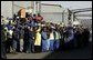 Workers at the Ford Motor Company plant watch as President Bush departs the plant near Pretoria, South Africa, Wednesday July 9, 2003. White House photo by Paul Morse.
