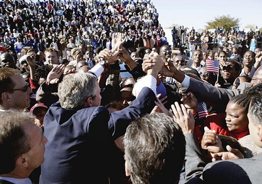 President George W. Bush greets an eager crowd upon his arrival at Sir Seretse Khama International Airport in Gaborone, Botswana, Thursday, July 10, 2003.