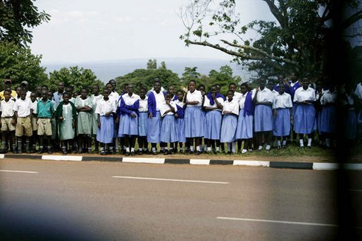 School children watch as the Presidential motorcade passes through Entebee, Uganda, July 11, 2003. White House photo by Paul Morse.