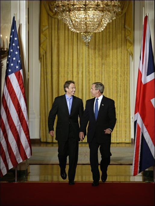 President George W. Bush and British Prime Minister Tony Blair walk through the Cross Hall of the White House before the start of their news conference, Thursday, July 17, 2003. White House photo by Paul Morse