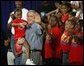 President George W. Bush joins children from Lakewest Family YMCA on stage after speaking on his Health and Fitness Initiative in Dallas, Texas, Friday, July 18, 2003. White House photo by Eric Draper.
