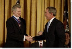 President George W. Bush presents the Presidential Medal of Freedom to Van Cliburn during a ceremony in the East Room Wednesday, July 23, 2003. Mr. Cliburn is a concert pianist whose talents have inspired countless artists.  White House photo by Paul Morse