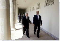 President George W. Bush and Palestinian Prime Minister Mahmoud Abbas walk along the colonnade after their joint press conference in the Rose Garden Friday, July 25, 2003. Meeting for the first time at the White House, the two leaders held a working lunch and a meeting in the Oval Office.  White House photo by Paul Morse
