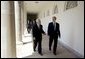 President George W. Bush and Palestinian Prime Minister Mahmoud Abbas walk along the colonnade after their joint press conference in the Rose Garden Friday, July 25, 2003. Meeting for the first time at the White House, the two leaders held a working lunch and a meeting in the Oval Office. White House photo by Paul Morse.