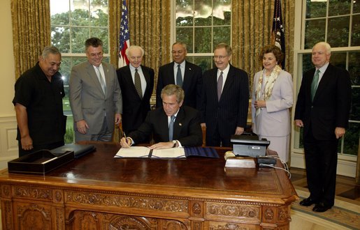 President George W. Bush signs the Burmese Freedom and Democracy Act in the Oval Office Monday, July 28, 2003. White House photo by Susan Sterner.