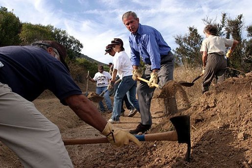 Working alongside volunteers, President George W. Bush lends a hand in repairing the Old Boney Trail at the Santa Monica Mountains National Recreation Area in Thousand Oaks, Calif., August 15, 2003. White House photo by Paul Morse.