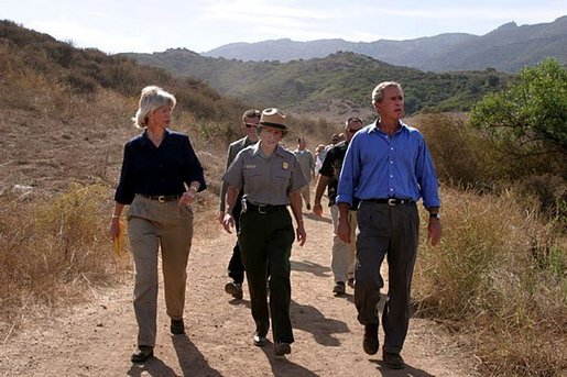 President George W. Bush walks with Secretary of the Interior Gale Norton, left, and Director of the National Park Service Fran Mainella at the Santa Monica Mountains National Recreation Area in Thousand Oaks, Calif., August 15, 2003. White House photo by Paul Morse.