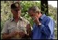 President George W. Bush smells a branch of sage with Ralph Waycott, volunteer coordinator of the Rancho Sierra Vista Nursery, during a tour of the Santa Monica Mountains National Recreation Area in Thousand Oaks, Calif., August 15, 2003. White House photo by Paul Morse.