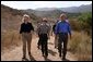 President George W. Bush walks with Secretary of the Interior Gale Norton, left, and Director of the National Park Service Fran Mainella at the Santa Monica Mountains National Recreation Area in Thousand Oaks, Calif. File photo. White House photo by Paul Morse.