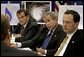 Sitting with Homeland Security Secretary Tom Ridge, left, and Under Secretary Mike Brown of FEMA, President George W. Bush receives a briefing on the damage inflicted by Hurricane Isabel during a tour of the temporary operations center at the Virginia State Police Academy in Richmond, Va., Monday, Sept. 22, 2003.  White House photo by Paul Morse