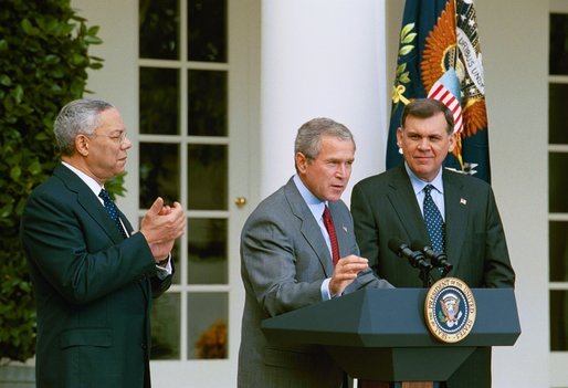 President George W. Bush discusses America's policies regarding Cuba as Secretary of State Colin Powell, left, and Secretary of Housing and Urban Development Mel Martinez stand by his side in the Rose Garden Friday, Oct. 10, 2003. "We will increase the number of new Cuban immigrants we welcome every year," said the President. "We are free to do so, and we will, for the good of those who seek freedom. Our goal is to help more Cubans safely complete their journey to a free land.".