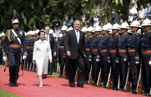 President George W. Bush inspects troops with Philippine president Gloria Arroyo during a welcoming ceremony at Malacanang Palace in Manila, The Philippines along and Mrs. Laura Bush on Saturday October 18, 2003 White House photo by Paul Morse.