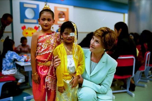 Laura Bush embraces a little girl at the National Institute of Child Health in Bangkok, Thailand, Oct. 21, 2003. White House photo by Tina Hager.