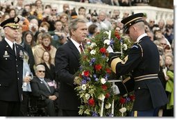 Honoring those who died in service to America, President George W. Bush lays a wreath at the Tomb of the Unknowns in Arlington Cemetery on Veterans Day Nov. 11, 2003. After the wreath was placed, "Taps" was played and a moment of silence was observed.  White House photo by Paul Morse