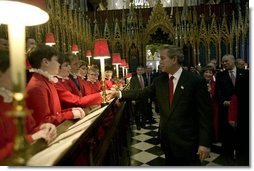 After listening to the Westminster Abbey Choir perform, President George W. Bush greets one of the younger choir members during his and Mrs. Bush's tour of the abbey Thursday, Nov. 20, 2003.  White House photo by Eric Draper