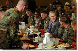 President George W. Bush enjoys lunch with U.S. soldiers at Fort Carson, Colorado Nov. 24, 2003.  White House photo by Tina Hager