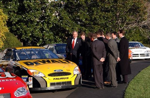 President George W. Bush jokes with NASCAR racers after looking over the stock cars parked on the South Lawn Tuesday, Dec. 2, 2003. "I've hosted champions from many sports here at the White House, this is the first time, however, we ever parked stock cars in the South Lawn," President Bush said. White House photo by Tina Hager.