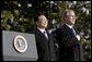 President George W. Bush and Premier Wen Jiabao of China stand for the playing their national anthems during an Arrival Ceremony on the South Lawn Tuesday, Dec. 9, 2003.   White House photo by Paul Morse
