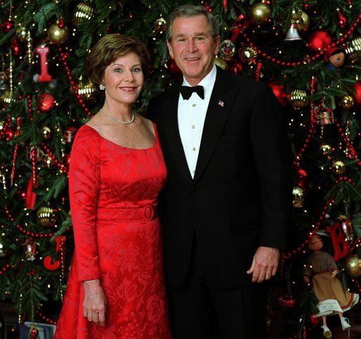 President George W. Bush and Laura Bush pose for their official Christmas portrait in front of the White House Christmas Tree in the Blue Room, Dec. 7, 2003. This year's holiday theme at the White House celebrates children's storybook characters with, "A Season of Stories." More information about the theme and decorations can be viewed at www.whitehouse.gov/holiday/. White House photo by Eric Draper