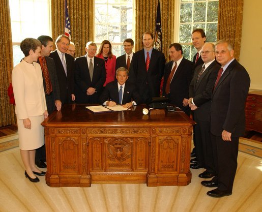 President George W. Bush pauses before signing the Controlling the Non-Solicited Pornography and Marketing Act of 2003, which establishes a framework of administrative, civil and criminal tools to help America’s consumers, businesses and families combat SPAM, in the Oval Office Tuesday, Dec. 16, 2003. Pictured with the President are from left to right: Rep. Heather Wilson, (R, NM); Garry Betty, President and CEO of Earthlink; Rep. Edward Markey (D, MA); Rep. Rick Boucher (D, VA); Sen. Conrad Burns (R, MT); Rep. Melissa Hart (R, PA; Sen. Bill Frist (R, TN); Sen. Ron Wyden (D, OR); Rep. Chris Cannon (R, UT); Jonathan Miller, Chairman and CEO of America Online; Maynard Webb, Chief Operating Officer of eBay; Rep. Gene Green (D, TX). White House photo by Tina Hager.