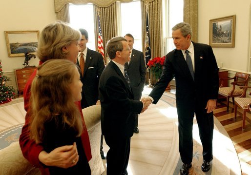 President George W. Bush congratulates Senator Mike DeWine, R-Ohio, on S. 650, the Pediatric Equity Research Act of 2003, in the Oval Office Tuesday, Dec. 16, 2003. Senator DeWine's daughter and wife, Fran, are pictured at the left. Also pictured are Senator Bill Frist, R-Tenn., left, and Health and Human Services Secretary Tommy Thompson. The act gives the Food and Drug Administration the authority to require drug companies to conduct safety tests on pharmaceuticals that are to be administered to children. The President signed the bill into law Dec. 3, 2003. White House photo by Tina Hager.