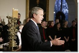 President George W. Bush comments to the press after lighting a menorah Wednesday afternoon December 22, 2003 at the White House.  White House photo by Paul Morse