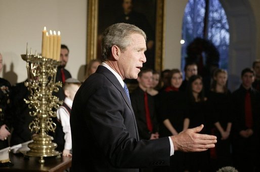 President George W. Bush comments to the press after lighting a menorah Wednesday afternoon December 22, 2003 at the White House. White House photo by Paul Morse