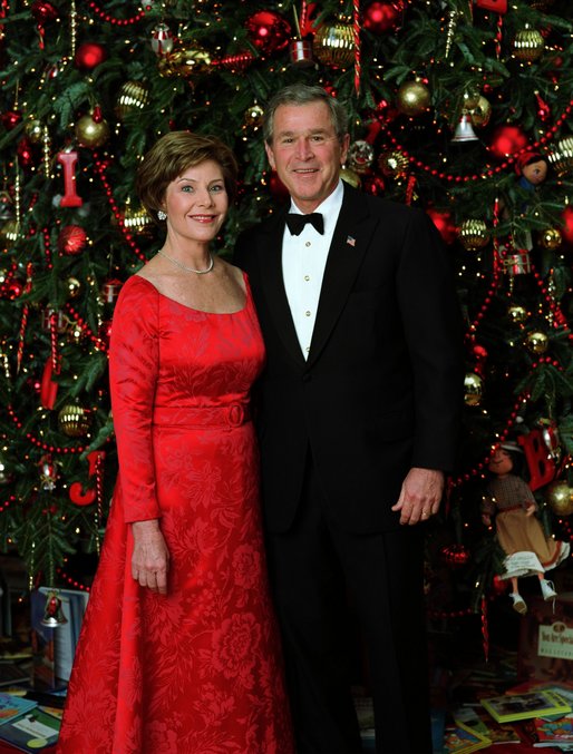 Celebrating the 2003 holiday season, President George W. Bush and Laura Bush pose for a Christmas portrait in front of the White House Christmas Tree. White House photo by Eric Draper.