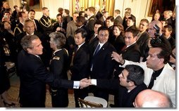 President George W. Bush greets enthusiastic audience members after discussing his immigration policy in the East Room Wednesday, Jan. 7, 2004.  White House photo by Paul Morse