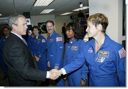 President George W. Bush greets shuttle astronauts from right, Peggy Whitson, Stephanie Wilson, and John Grunsfeld, and Ellen Ochoa at NASA headquarters in Washington, D.C., Wednesday, Jan. 14, 2004. The President committed the United States to a long-term human and robotic program to explore the solar system, starting with a return to the Moon that will ultimately enable future exploration of Mars and other destinations.  White House photo by Eric Draper