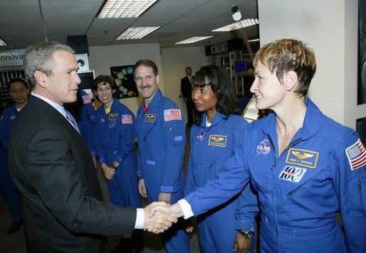 President George W. Bush greets shuttle astronauts from right, Peggy Whitson, Stephanie Wilson, and John Grunsfeld, and Ellen Ochoa at NASA headquarters in Washington, D.C., Wednesday, Jan. 14, 2004. The President committed the United States to a long-term human and robotic program to explore the solar system, starting with a return to the Moon that will ultimately enable future exploration of Mars and other destinations. White House photo by Eric Draper.