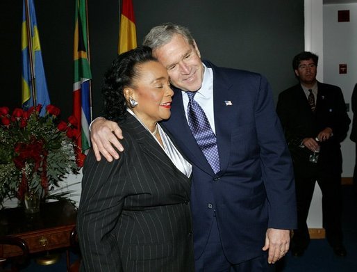 President George W. Bush hugs Coretta Scott King after laying a wreath laying at the grave of Dr. Martin Luther King JR. in Atlanta, Georgia, Thursday, Jan. 15, 2004. White House photo by Eric Draper