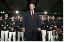 President George W. Bush stands on stage during his introduction before speaking on the war on terror at the Roswell Convention Center in Roswell, New Mexico, Thursday, Jan. 22, 2004.  White House photo by Eric Draper