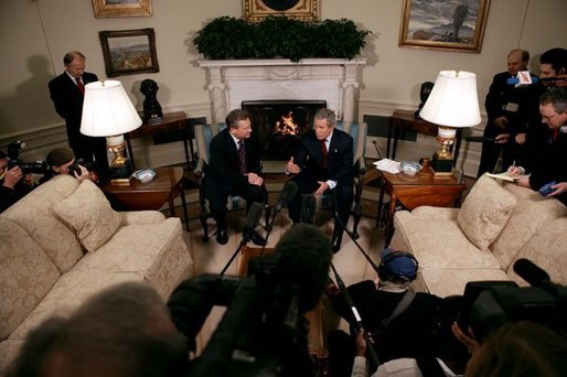 President George W. Bush and President Aleksander Kwasniewski talk with the press in the Oval Office Tuesday, Jan. 27, 2004. After their meeting, President Bush hosted a lunch for President Kwasniewski. White House photo by Eric Draper
