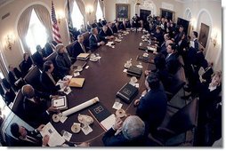 Seen through a fish-eye lens, President George W. Bush talks with reporters during a Cabinet Meeting at the White House Monday, Feb. 2, 2004.  White House photo by Eric Draper
