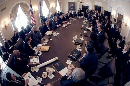Seen through a fish-eye lens, President George W. Bush talks with reporters during a Cabinet Meeting at the White House Monday, Feb. 2, 2004. White House photo by Eric Draper.