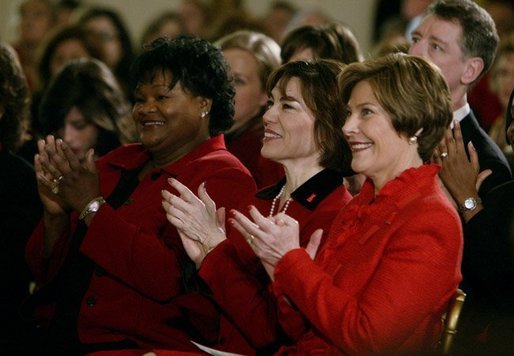 Laura Bush listsens with Assistant Secretary for Health (acting) Dr. Cristina Beato, center, and heart attack survivor Joyce Cullen, left, during White House ceremonies to launch American Heart Month. The event, part of the national Heart Truth campaign, was held to highlight the issue of heart disease as the number-one killer of women in the United States. Monday, Feb. 2, 2004. White House photo by Susan Sterner