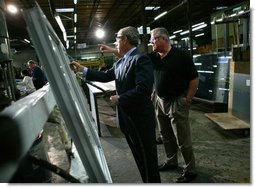President George W. Bush participates in a tour of Nu-Air Manufacturing Company with employee Marshall Hartley in Tampa, Florida, Monday, Feb. 16, 2004.  White House photo by Eric Draper
