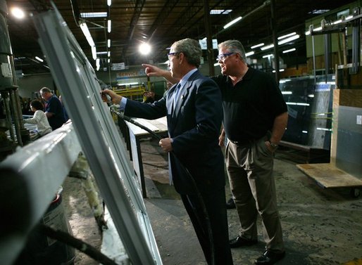 President George W. Bush participates in a tour of Nu-Air Manufacturing Company with employee Marshall Hartley in Tampa, Florida, Monday, Feb. 16, 2004. White House photo by Eric Draper