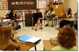 Laura Bush talks with history students at Bentonville High School in Bentonville, Ark., Tuesday, Feb. 17, 2004. "We'll need more than 2 million new teachers in America's classrooms in the next decade," said Mrs. Bush in her remarks about education. "We want teachers with diverse academic backgrounds who will commit to teaching in urban or rural public schools, where teachers are desperately needed."  White House photo by Tina Hager