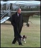 The President George W. Bush and Spot walk across the South Lawn following the President's arrival aboard Marine One, Jan. 15, 2002. White House photo by Paul Morse.