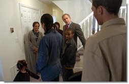 President George W. Bush visits with Pearl Cerdan and her four children in Ardmore, Pa., Monday, March 15, 2004. Ms. Cerdan, a first-time homebuyer, moved into her Spring Avenue Development home in December of 2003.  White House photo by Tina Hager