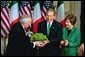 President George W. Bush and Laura Bush receive a bowl of Shamrock from Ireland's Prime Minister Bertie Ahren during the annual ceremony celebrating St. Patrick's Day in the Roosevelt Room Wednesday, March 17, 2004.  White House photo by Tina Hager