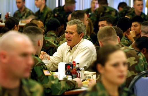 President George W. Bush and Laura Bush, not pictured, sit down for lunch with soldiers at Fort Campbell, Ky., Thursday, March 18, 2004. "Here, at one of America’s vital military bases, you’ve built a strong community of people who care about each other, and share the challenges and rewards of army life. America is grateful. America is proud of our military families," said the President in his remarks." White House photo by Tina Hager