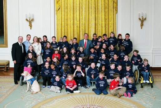 President George W. Bush poses for a photograph with the Children’s Miracle Network Champions Across America Representatives in the East Room of the White House Monday, March 22, 2004. The Champions are children who have battled a wide range of challenges, including birth defects, cancer and life-threatening injuries. They now serve as ambassadors for the network. White House photo by Tina Hager.