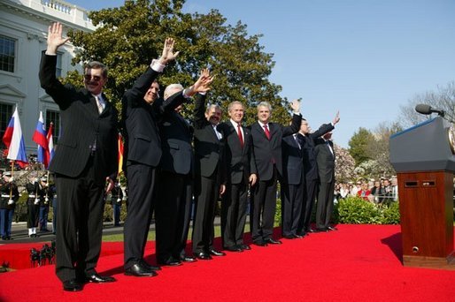 President George W. Bush waves with Prime Ministers of seven countries after a South Lawn ceremony welcoming them into NATO Monday, March 29, 2004. From left are: Prime Minister Indulis Emsis of Latvia, Prime Minister Anton Rop of Slovenia, Prime Minister Algirdas Brazauskas of Lithuania, Prime Minister Mikulas Dzurinda of the Slovak Republic, President George W. Bush, Prime Minister Adrian Nastase of Romania, Prime Minister Simeon Saxe-Coburg Gotha of Bulgaria, Prime Minister Juhan Parts of Estonia, and NATO Secretary General Jaap de Hoop Scheffer. White House photo by Susan Sterner