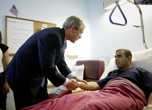 President George W. Bush congratulates U.S. Army First Class Ismael Torres after presenting him The Purple Heart medal at Darnall Army Community Hospital in Ft. Hood, Texas, Sunday, April 11, 2004. Torres was injured while serving in Operation Iraqi Freedom. White House photo by Eric Draper.